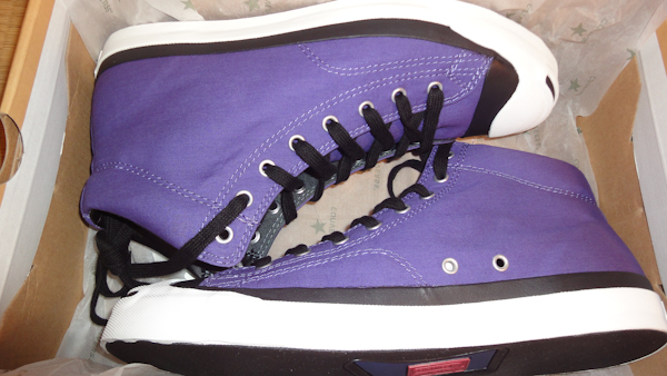a box containing purple running shoes